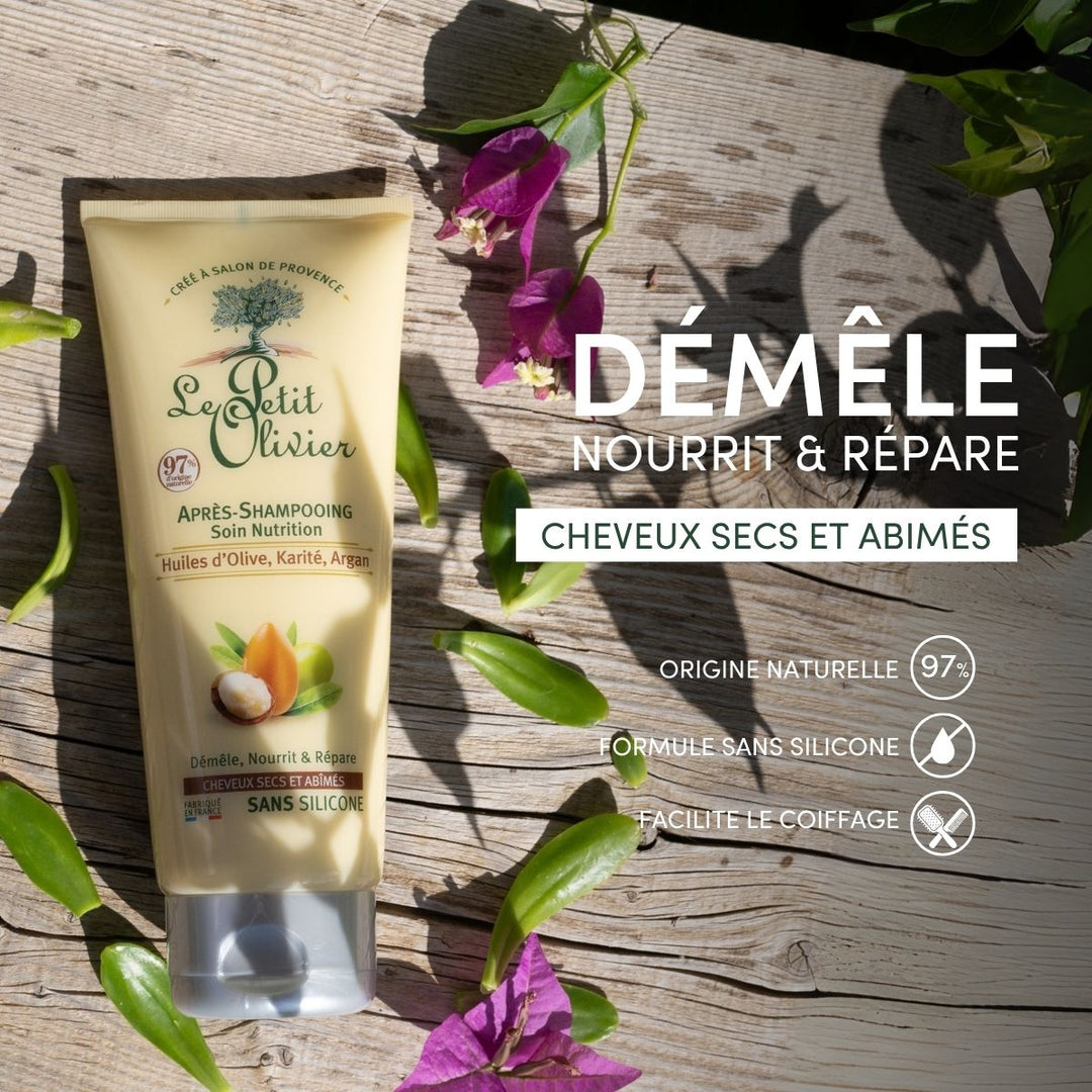 Un tube d'après-shampoing « Le Petit Olivier » pour cheveux secs et abîmés repose sur un fond en bois parsemé de fleurs. L'emballage met en avant des « huiles précieuses », une composition à 97 % d'origine naturelle et une formule sans silicone destinée aux cheveux secs et abîmés.
