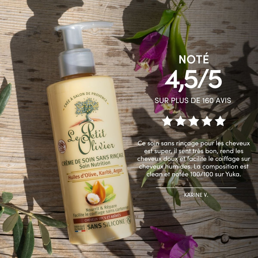 Un flacon de « Le Petit Olivier Crème de Soin Cheveux Secs et Abîmés » est posé sur une surface en pierre ornée de fleurs violettes et de feuilles vertes. Le texte indique une note de 4,5/5 et un avis client positif.