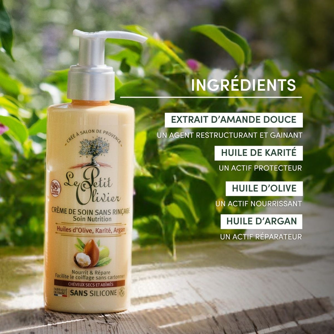 Un flacon de « Le Petit Olivier Crème de Soin Cheveux Secs et Abîmés » est posé sur une surface en bois. Idéale pour les cheveux secs et abîmés, ses ingrédients sont présentés à droite, avec une végétation floue en arrière-plan.