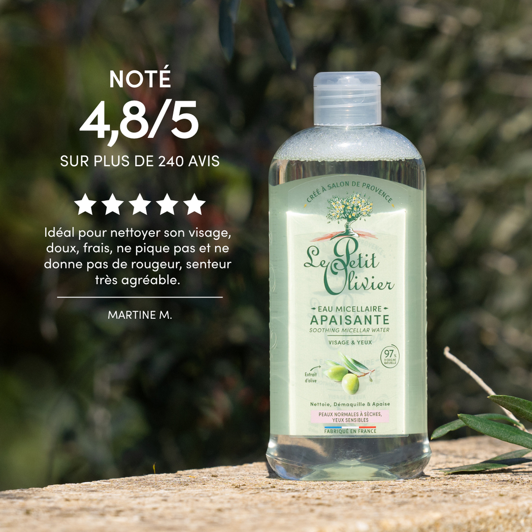 Une bouteille de « Le Petit Olivier Eau Micellaire Démaquillante Visage & Yeux Sensibles » est photographiée en extérieur, posée sur une pierre entourée de verdure. Le texte vante son pouvoir nettoyant tout en douceur pour les peaux sensibles et met en avant une note de 4,8/5 ainsi que des avis positifs.