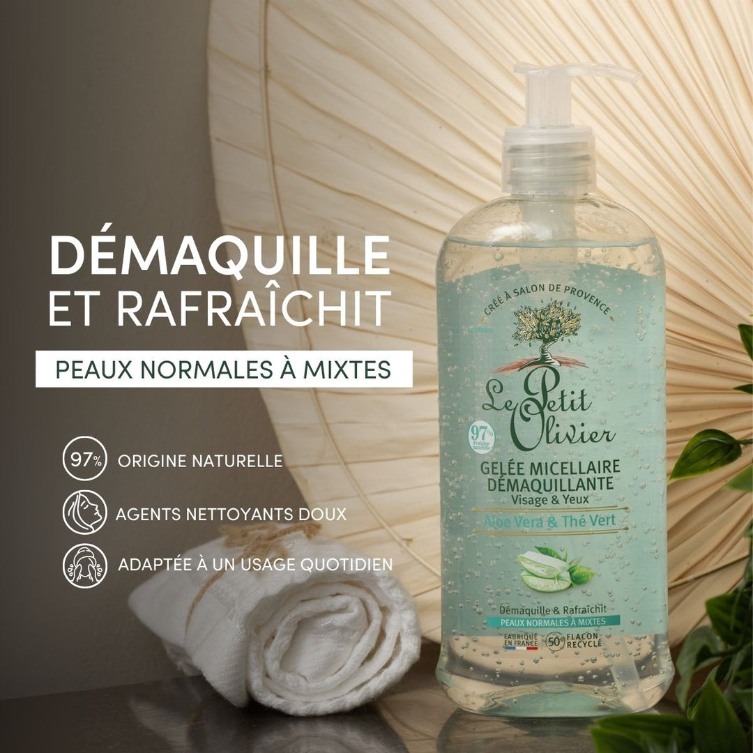 A bottle of Gelée Micellaire Démaquillante Visage & Yeux stands next to a rolled white towel and green leaves, with French text highlighting its natural origin, gentle cleansing, and suitability for normal to combination skin.
