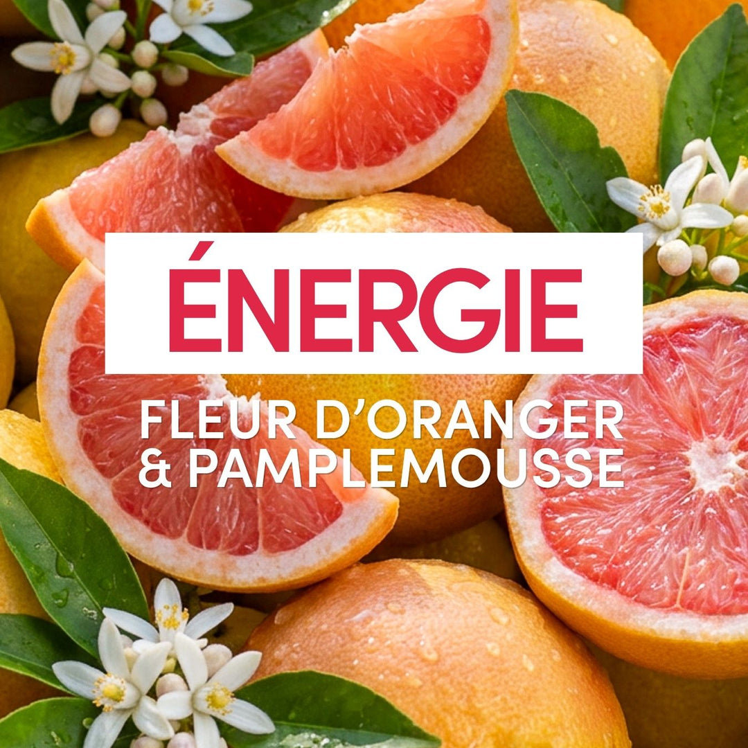 Un pamplemousse coupé en deux et un pamplemousse entier, accompagnés de feuilles vertes et de fleurs blanches, s’estompent derrière un texte en caractères gras : « Gel Douche Énergie » de Le Petit Olivier, aux notes de fleur d’oranger et de pamplemousse, pour une douche rafraîchissante et hydratante.