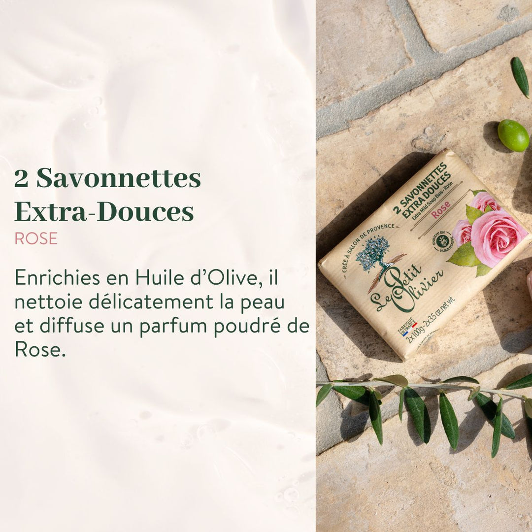 Un « Pack Découverte » des savonnettes « Extra Douces » de Le Petit Olivier, enrichies en huile d'olive et fabriquées en France, est présenté sur une pierre, entouré de feuilles vertes, d'une rose rose, sur un fond blanc crème, avec une description du produit en français.