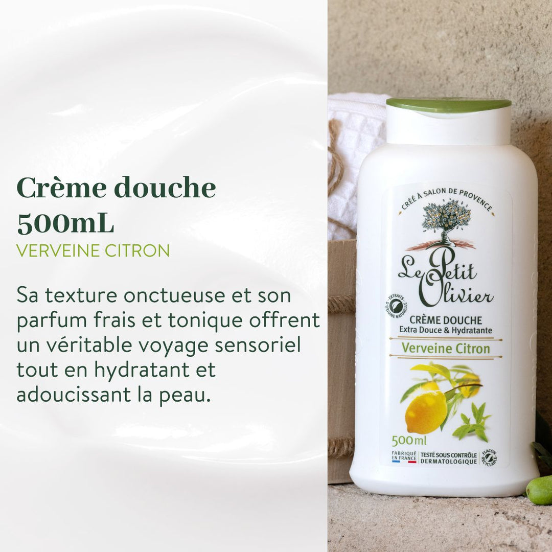 Une bouteille de 500 ml issue du coffret « Découverte - Crèmes Douches » de Le Petit Olivier repose sur une surface en pierre, à côté d'une serviette et d'un citron, mettant en avant ses propriétés adoucissantes et son parfum frais de verveine et de citron. L'étiquette précise qu'elle est fabriquée en France.
