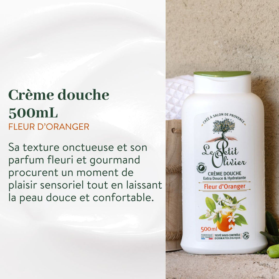 Un flacon issu du Pack Découverte - Crèmes de douche 500 ml de Le Petit Olivier repose sur une surface en pierre, à côté d'une serviette blanche et de feuilles vertes. Un texte en français, à gauche, met en avant sa qualité et son origine « fabriqué en France ».