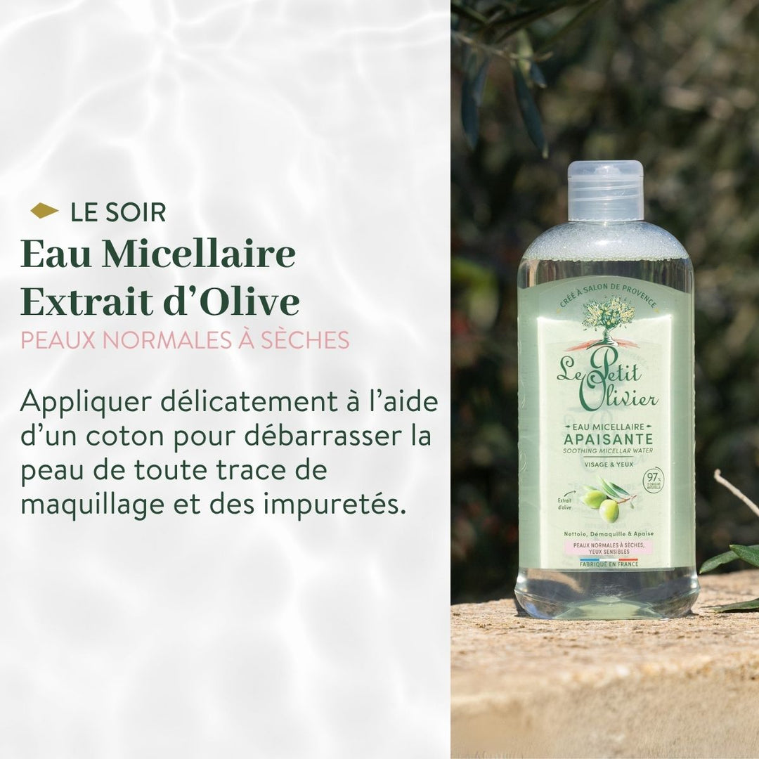 Un flacon de « Le Petit Olivier Rituel Soin Visage Express Douceur » repose sur une pierre à l'extérieur. Sa formule est adaptée aux peaux normales à sèches ; elle permet d'éliminer en douceur le maquillage et les impuretés à l'aide d'un coton, chaque soir.